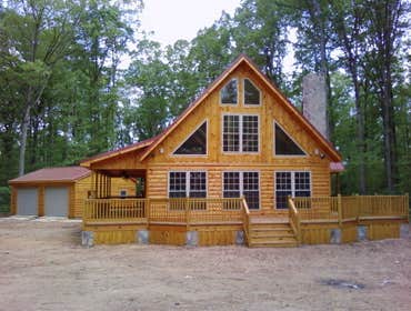 J & K Construction Project 1 Slate patio.two car garage with living and bath upstairs
Custom frame house with log siding.
New construction four ca