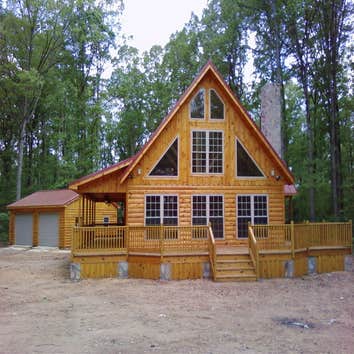 J & K Construction Project 1 Slate patio.two car garage with living and bath upstairs
Custom frame house with log siding.
New construction four ca