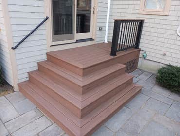 Azek Mahogany Decking with Cascading Stairs and Azek Mahogany Drink Rail on Black Composite Railing