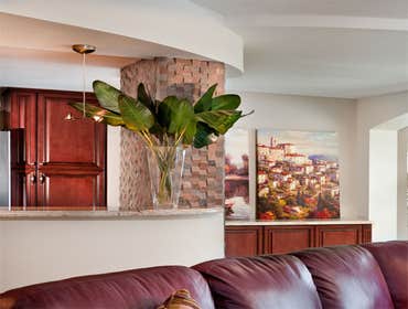 Oceanfront Condo Renovation Opening up the Kitchen allowed expansive ocean views while cooking and entertaining guests! A stunning Powder Room was also
