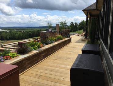 Deck Build Multilevel deck with built in fire wall, wrought iron hand rails, and flower beds.