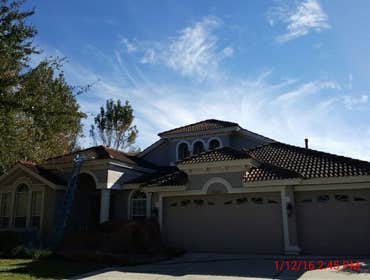 Photos from Popa Construction LLC Before & Afters of a soft wash roof cleaning and driveway and side walk cleaning.