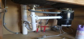 Under Kitchen sink piping and garbage disposal