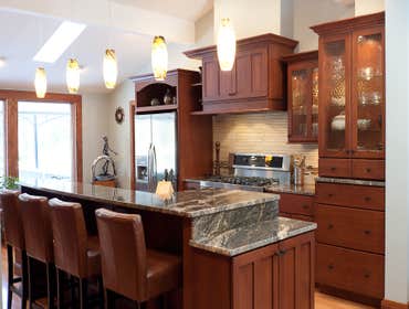 Meadville Two Tone This is a beautiful kitchen with Aurora White Perimeter Cabinets and Two Cherry Islands. All work from design to install of everyth