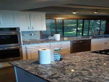 Henderson Kitchen Remodel Reface kitchen cabinets and new cab doors. New granite counters with stainless steel sink and faucet. New Laminate flooring a