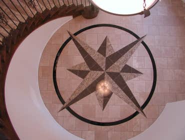 Custom 12' custom compass rose on the floor of a spiral stairwell For the client of this brand new custom home we designed, fabricated, and installed t