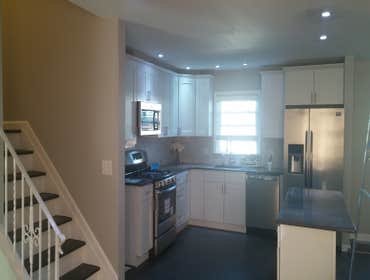 Kitchen White Shaker Installation of 6x12 wood look tile, Kitchen with Quartz counter top and back splash