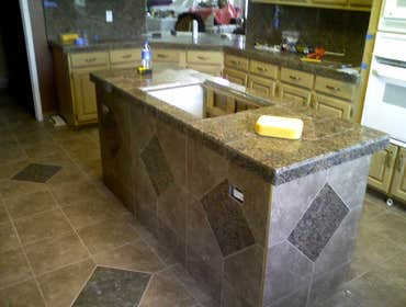 Othello Kitchen Granite/Porcelain Tile Work Kitchen Countertops and Backsplash done in Granite tile with hand beveled and polished edges and floors don