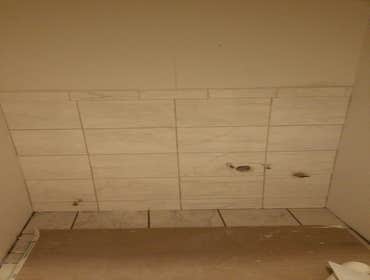 Install tile in the bathroom walls and floor