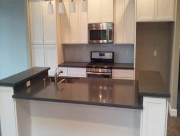 Quartz slab kitchen with glass