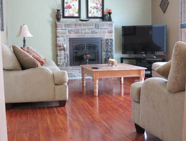 A family's living room and kitchen installed with laminate This project started out with us removing the old existing carpet in the living room and old