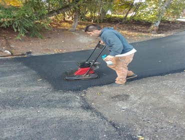 Asphalt driveway Grade area for new asphalt driveway to be installed, install hot asphalt driveway 3 to 5 inches thick, racked and rolled with roller a