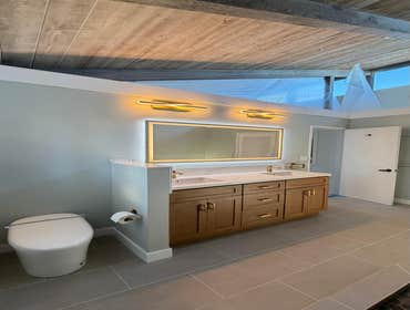Photos by Ma Properties Construction #1 This bathroom remodel transformed an outdated space into a modern, functional retreat. The project included a c