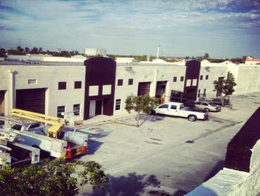 repainting warehouse in Hialeah Pressure washed, one coat of primer two coats of paint