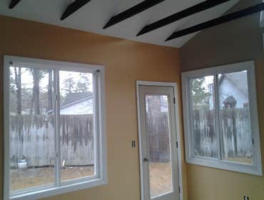 sun room 16x16 concrete slab with 8" lap siding.