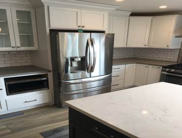 Photos by Currier Construction Co #1 Remove 2 walls to open kitchen, re design the layout, install new window and slider door, new tile flooring throug
