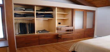 Custom Closet The homeowner of this contemporary timber frame home wanted a sleek closet system integrated into their bedroom that combined enclosed st