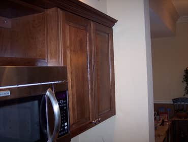 Mc Evoy's Custom kitchen cabinets made in maple and stained in a custom color matching wood floor in bedrooms.
