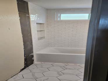 Custom shower over tub Custom tile shower installation over tub. Budget consisted of rough materials and installation only, tile was separate.