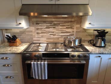 Bob's Kitchen Kitchen remodel in North Andover. Featuring granite counter tops on new white Cabico cabinets, and cherry island with a microwave drawer