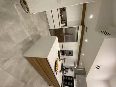 Photos by Eco Design Pro #7 Complete home renovation with custom kitchen, big island with Quartz counter top and rain fall. Porcelain tile on the floor