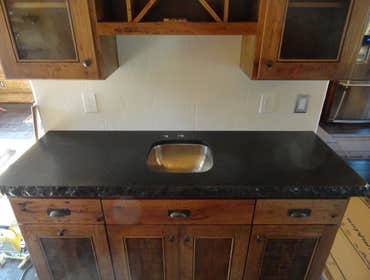 Kitchen Remodel 2 This Kitchen has a granite windowsill that matches the counters, and a bar done in a contrasting color. Both counters come installed 