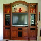 P S Woodworking Project Custom built-in arched Cherry media center with fluted columns and speakers integrated into doors & drawer fronts. Designed & h