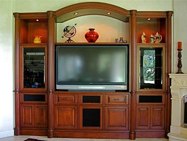 P S Woodworking Project Custom built-in arched Cherry media center with fluted columns and speakers integrated into doors & drawer fronts. Designed & h
