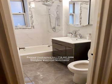David's Bathroom Renovation The primary bathroom boasts a private shower and tub, a customized walk-in shower with frameless shower doors, and a stunni