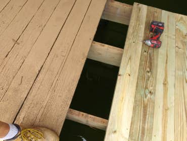 Photos by Peak Resolutions Group #6 R&R Existing Deck Floor, Handrails, Stairs and Boat House. Stabilize Frame Joists and Realign Deck Guttering System