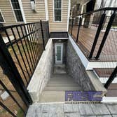 Photos by Farside Construction LLC #1 Newly constructed covered deck with standing seam cathedral style gable roof. Excavated and built a walk out egre