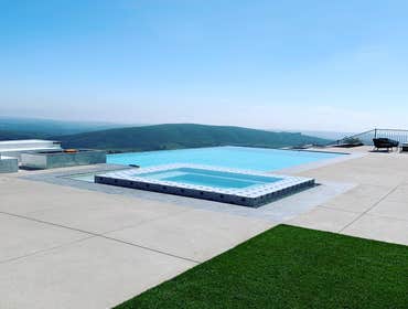 Photos by Bp Water Concepts Inc #1 Laurent edge pool, negative edge, with an overflow spa.