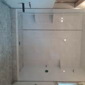 ceramic wall tiles, with black pencil liner trim on 2 walls, 3 carrera marble soap dishes, schluter trim for side walls. marble hexagon on shower pan f