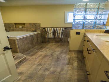 2014: Earthy Wood & Glass Master Bath This master bath originally had a typical builder’s tub and small shower. The purpose of the remodel was to open 