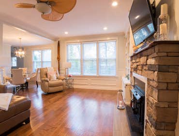 Custom Built-Ins & Stone Fireplace Living Room Fireplace with Natural Stone, Wood Burning Stove, Mahogany hand carved mantle and ceramic tile flooring.