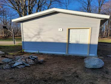 KVK LLC - PortLe Add a new garage, outbuilding, accessory structure. 12'x24' including new concrete slab 12'x36'.