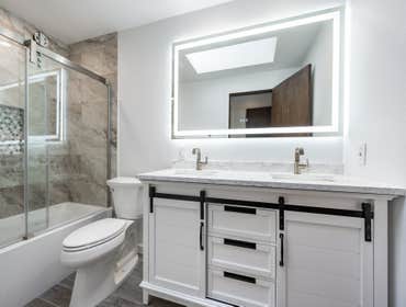 Full Bathroom Remodel Premium tiles, resilient countertops, chic vanities, sustainable fixtures, contemporary shower setups, and opulent bathtub.