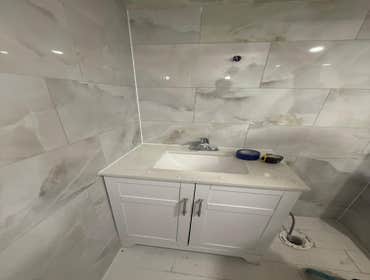 Photos by Strong Innovative Structures Inc #6 Bathroom renovation including installation of large-format wall tiles, floor tile installation, vanity an