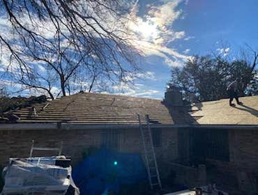 Re-roof includes wood shake removal and new decking