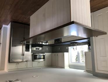 Yarmouth MA Complete renovation of home that had a fire. New kitchen with concrete countertops, white oak island, new bath, all new floors, windows, do