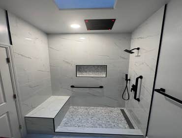 Danville Bathroom Remodel Custom shower with bench and niche, ceiling shower head with light, lighting, painting, floor tiles, baseboard, new vanity & 