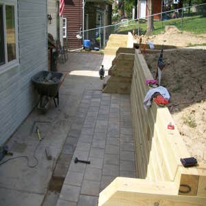 Project photos from Kotar Contracting Did deck last year around pool. Moved dirt and made a new retaining wall and patio bigger