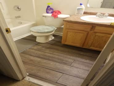 Photos by From the Ground Up #3 Removed ceramic tile from bathroom floor and installed vinyl planks.