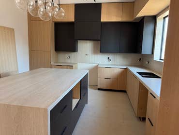 Kitchen Remodeling Complete kitchen remodel in Reseda, Los Angeles featuring custom cabinetry, quartz countertops, modern backsplash, under-cabinet lig