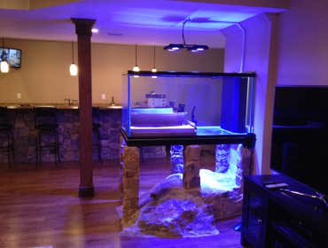 Finished Basement with Fish Tank on Granite Boulder: West Chester, PA Finished basement with full stone bar and powder room.
Designed around granite bo