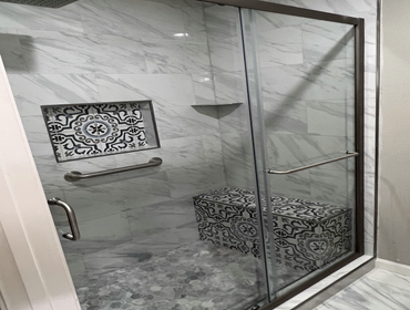 Livermore shower New shower with bench, shelf, hardware, niche, and glass.
