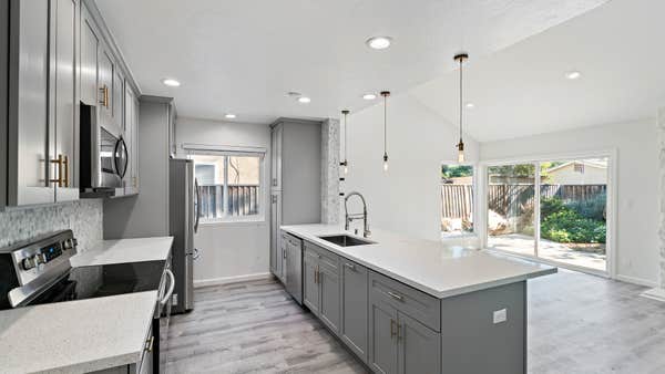 New countertops, sink, lighting, and modern cabinets