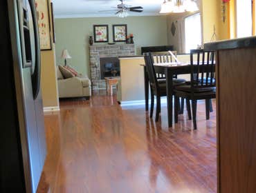 A family's living room and kitchen installed with laminate This project started out with us removing the old existing carpet in the living room and old