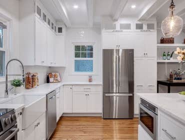 Photos by LCG BOSTON LLC #1 Full Home Remodel. Bathroom with custom glass, kitchen remodel with a beautiful exposed brick.