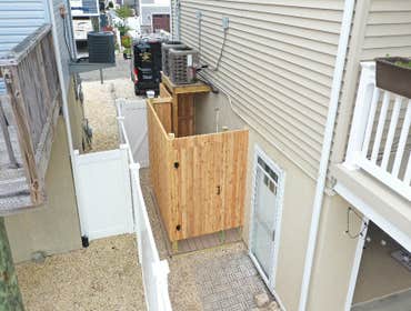 Photos by Mjf Carpentry LLC #1 Beautiful out door shower. All natural cedar walls, door and shelves with treated framing. Decking is Azak with a hidden